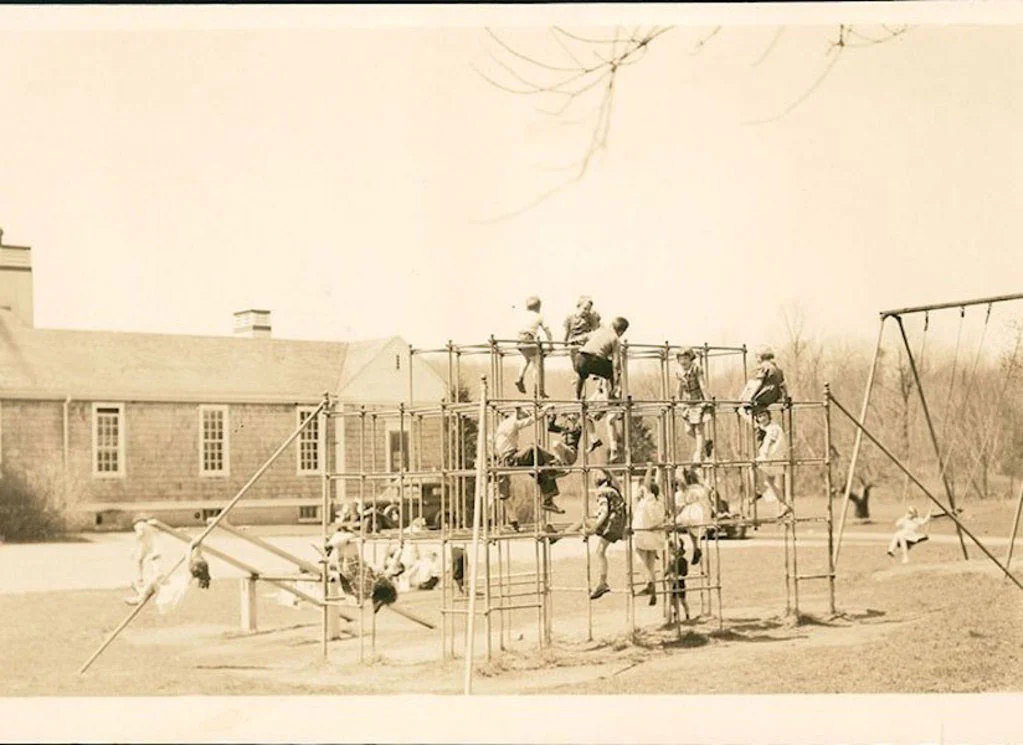 old photo of Meadowbrook students playing on a jungle gym