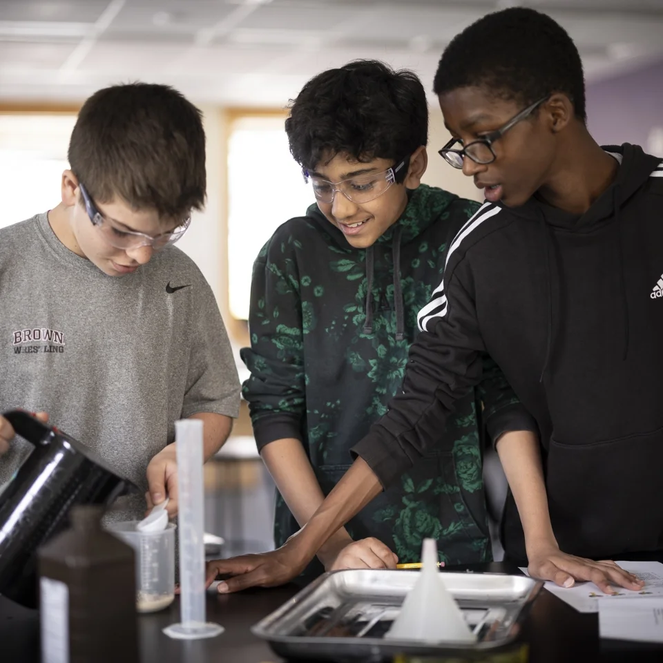 3 middle school students in science lab